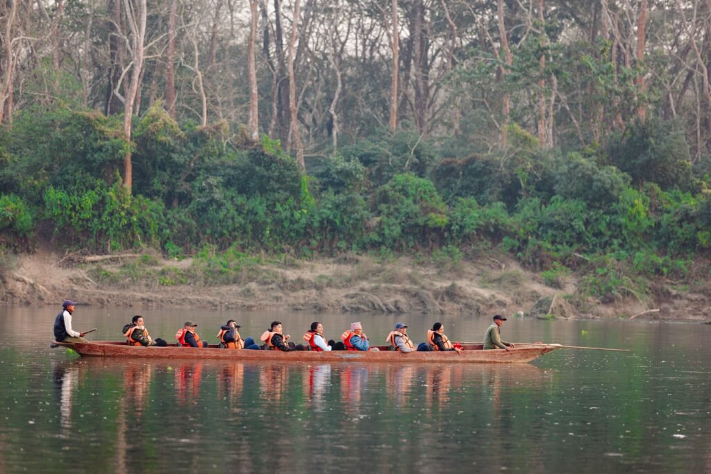 A group of tourists in a wooden canoe paddling along a calm forest river. Perfect for travel promotions.